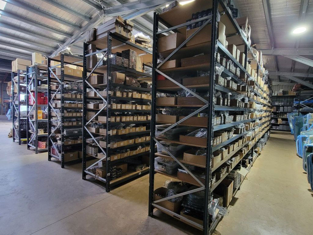 South Burnett Tractor Parts warehouse interior showing floor-to-ceiling racking stocked with parts